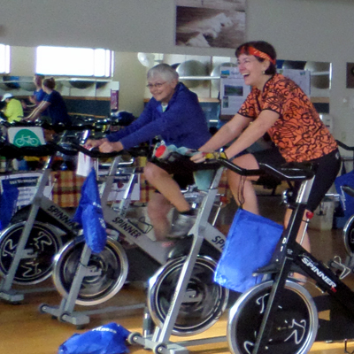 indoor cyclcists smiling