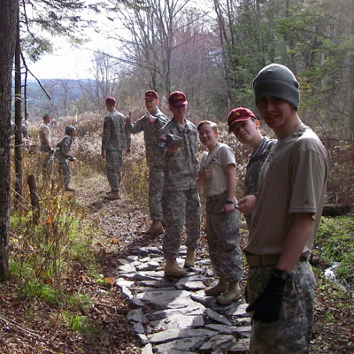 volunteers place rock on trail